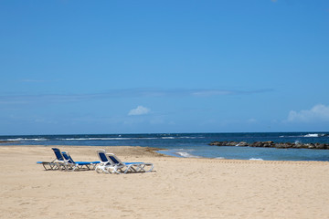 Pristine Caribbean beach with beach chairs
