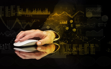 Hand using wireless mouse with financial concept on dark background
