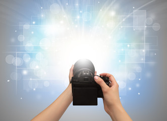 Naked hand taking picture with digital camera and glowing flash concept
