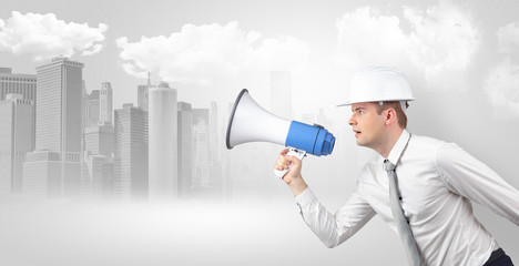 Fototapeta premium Young supervisor architect yelling to far big city panorama 