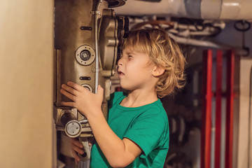 The boy looks through the periscope on the submarine
