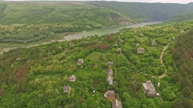 Amazing aerial view of small mountain village and river in Ukraine