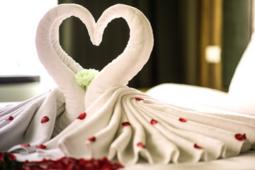 Bedroom bride and groom, luxury bedroom, white linen, white swan, red petal, red heart