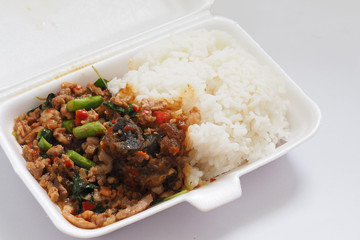 Pad Krapao Moo Sap or Fried Century Eggs with Minced Pork and Crispy Holy Basil Leaf On Rice In Foam Box For Take Home.