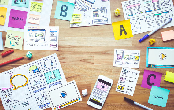 Business digital marketing with paperwork sketch on wood table.analysis strategy concepts