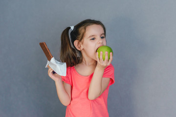 Sweet tooth baby chocolate or green Apple. Healthy and harmful food in baby food. Selective focus.	