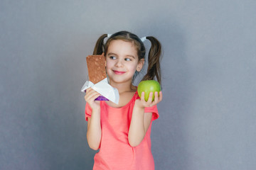 Sweet tooth baby chocolate or green Apple. Healthy and harmful food in baby food. Selective focus.	