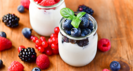  yogurt with raspberries, blackberries, currants, mint leaves. the concept of diet food and vitamins, Breakfast at the hotel. selective focus
