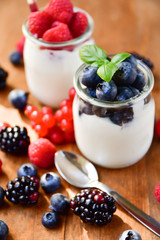  yogurt with raspberries, blackberries, currants, mint leaves. the concept of diet food and vitamins, Breakfast at the hotel. selective focus