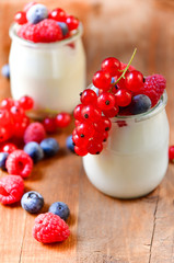  yogurt with raspberries, blackberries, currants, mint leaves. the concept of diet food and vitamins, Breakfast at the hotel. selective focus