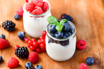  yogurt with raspberries, blackberries, currants, mint leaves. the concept of diet food and vitamins, Breakfast at the hotel. selective focus