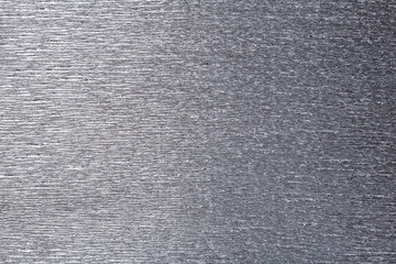 Textural of gray background of wavy corrugated paper, closeup.