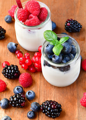  yogurt with raspberries, blackberries, currants, mint leaves. the concept of diet food and vitamins, Breakfast at the hotel. selective focus
