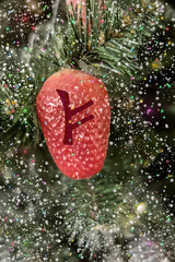 Fehu rune on Christmas background
