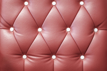 The maroon colored leather pattern of the sofa  