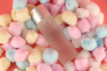 Facial cleansing toner on a pink background and cotton wool
