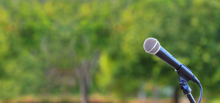 microphone standing for speaker on the outdoor natural setting for music, concert and environmental awareness talk with copy space