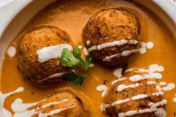 Malai Kofta Curry is a Mughlai special recipe served in a bowl. Selective focus