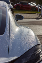 details of german sportscar body work with raindrops