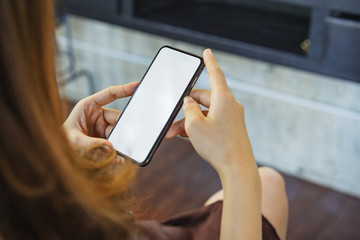 Cropped shot of a young businesswoman using on a smartphone in a modern office