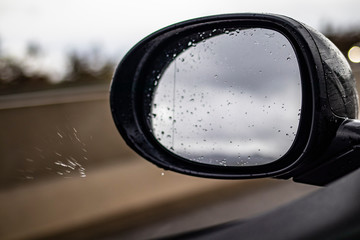 Left mirror car with rain drops
