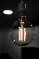 Old light bulb filament close up still on a dark background