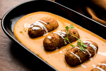Malai Kofta Curry is a Mughlai special recipe served in a bowl. Selective focus