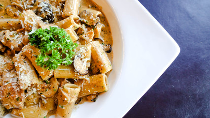 The Spaghetti Carbonara. Fettuccini pasta in white cream sauce with bacon.