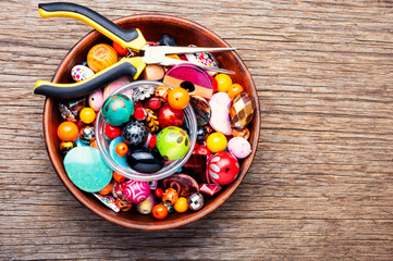 Colorful beads on a wooden surface