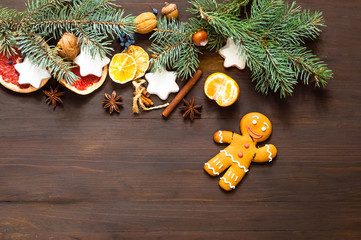 Christmas garland of fir branches and homemade cookies on wooden background. Flat lay, Top view. Copy space