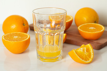 orange juice and oranges on a white background.