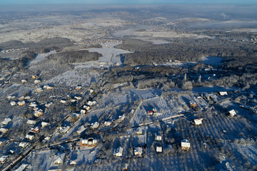 drone aerial view with houses and road in winter season