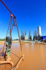 Drilling rig derrick and yellow water in MaCheng iron mine, China