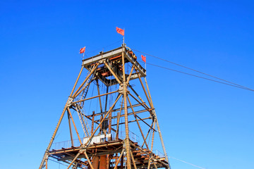 Fototapeta na wymiar Iron ore drilling derrick in the blue sky background