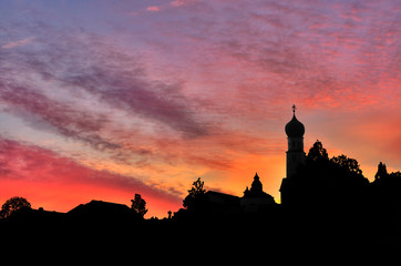 red and orange sunset village silhouette, shadow landscape with church