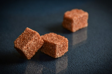 Three cubes of brown sugar.
