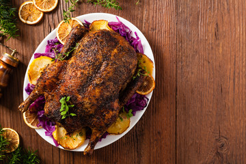 Baked whole duck, served with apples, red cabbage, oranges and roasted fritters.