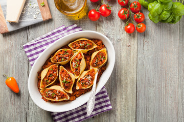 Italian pasta Conchiglioni Rigati stuffed with dry tomatoes and meat.