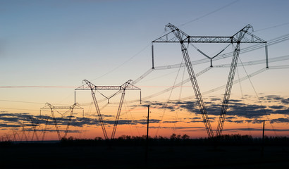high voltage power lines at dusk at sunset