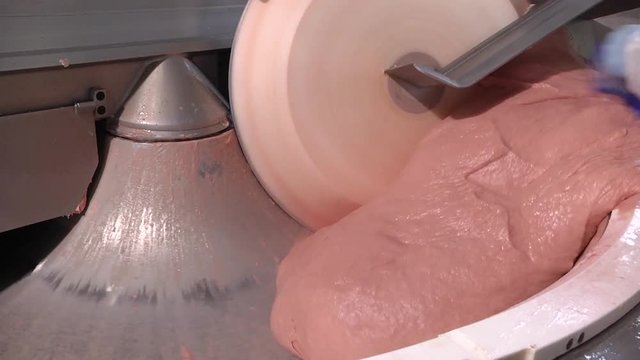 KUTTER FOR MEAT.  Fine grinding of soft meat raw materials. Mixing meat and spices for making hot dogs and sausages in a food factory