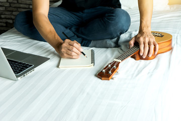 young man write a song or music