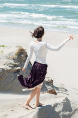 
Brunette woman in dress goes to sea
