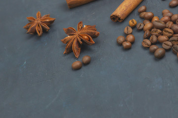 roasted coffee beans scattering in the corner of the background. beans on a dark background. view from above. copy space.