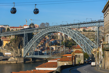 Fototapeta premium View of the famous bridge Ponte dom Luis and cable cars in Porto, Portugal