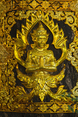 Brass plate carved in Thai style .