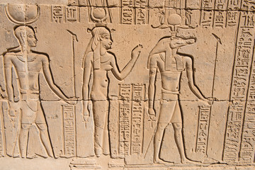 Hieroglyphic carvings on an ancient egyptian temple wall