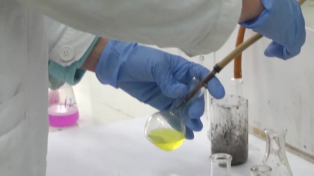 Lab worker analyzing meat sample magnifying glass. Laboratory studies of meat and meat products. Checking meat for compliance with sanitary requirements.