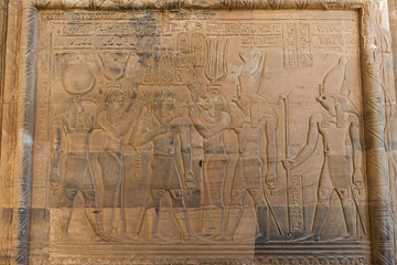 Hieroglyphic carvings on an ancient egyptian temple wall