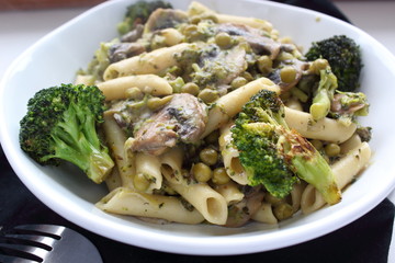 Penne pasta with vegetables and soy sauce in bowl.