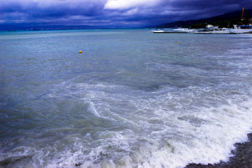 through the clouds over the sea a ray of sunshine makes its way